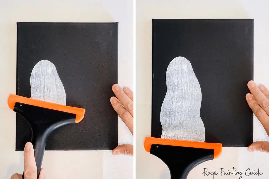 Easy Ghost Craft: Halloween Squeegee Painting for Kids 6 Pulling white acrylic paint with a squeegee to create a ghost shape