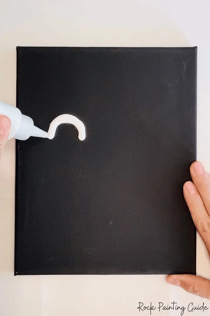 Easy Ghost Craft: Halloween Squeegee Painting for Kids 5 White acrylic paint added to black canvas for a squeegee ghost craft