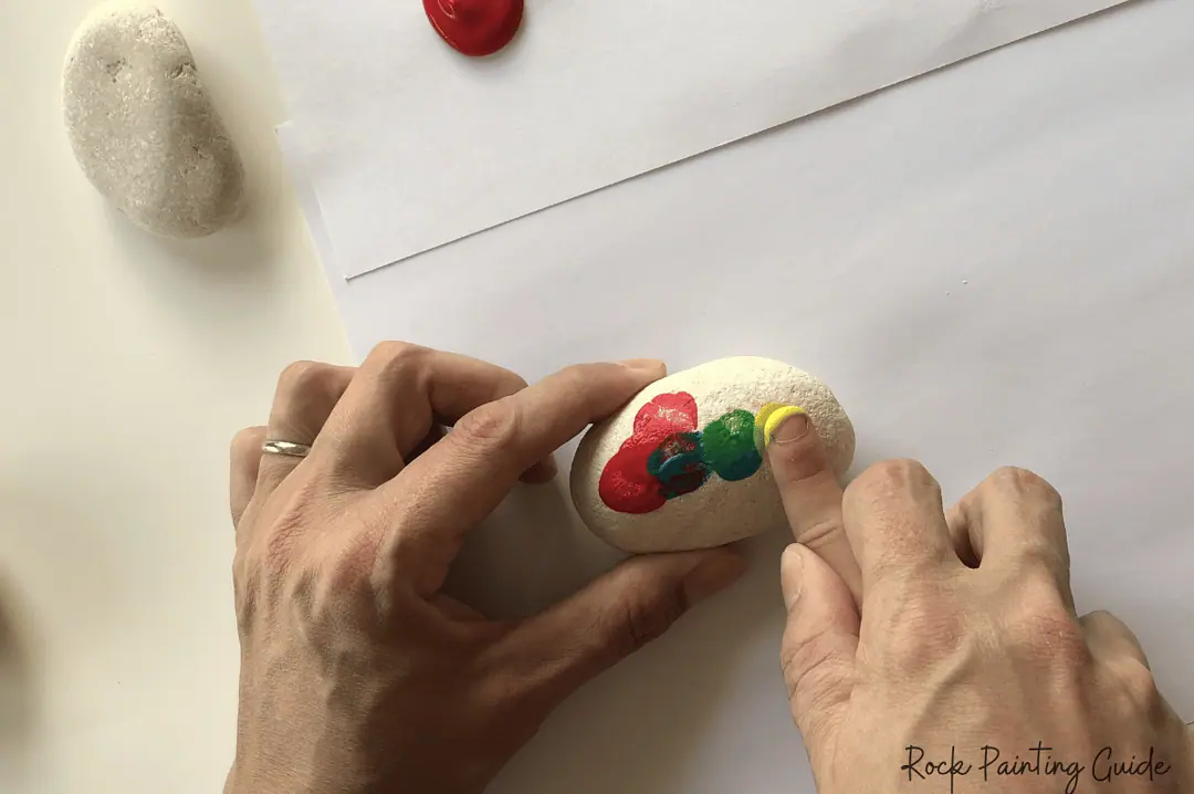 27 Fun Rock Painting Ideas For Preschoolers, No PaintBrush Required! 5 train painted rock made with finger painting