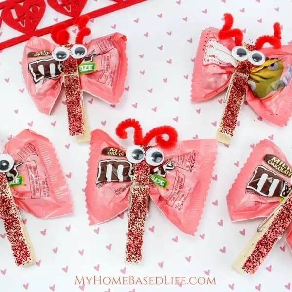 Cute Valentine's Day candy lollipops with googly eyes and pipe cleaner antennae.