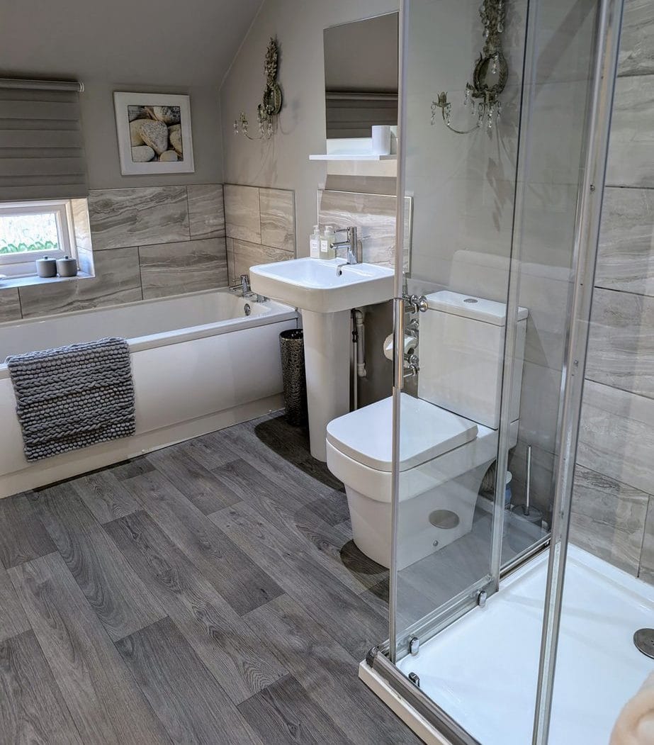 Bathroom at The Saddlery with bath and separate shower cubicle