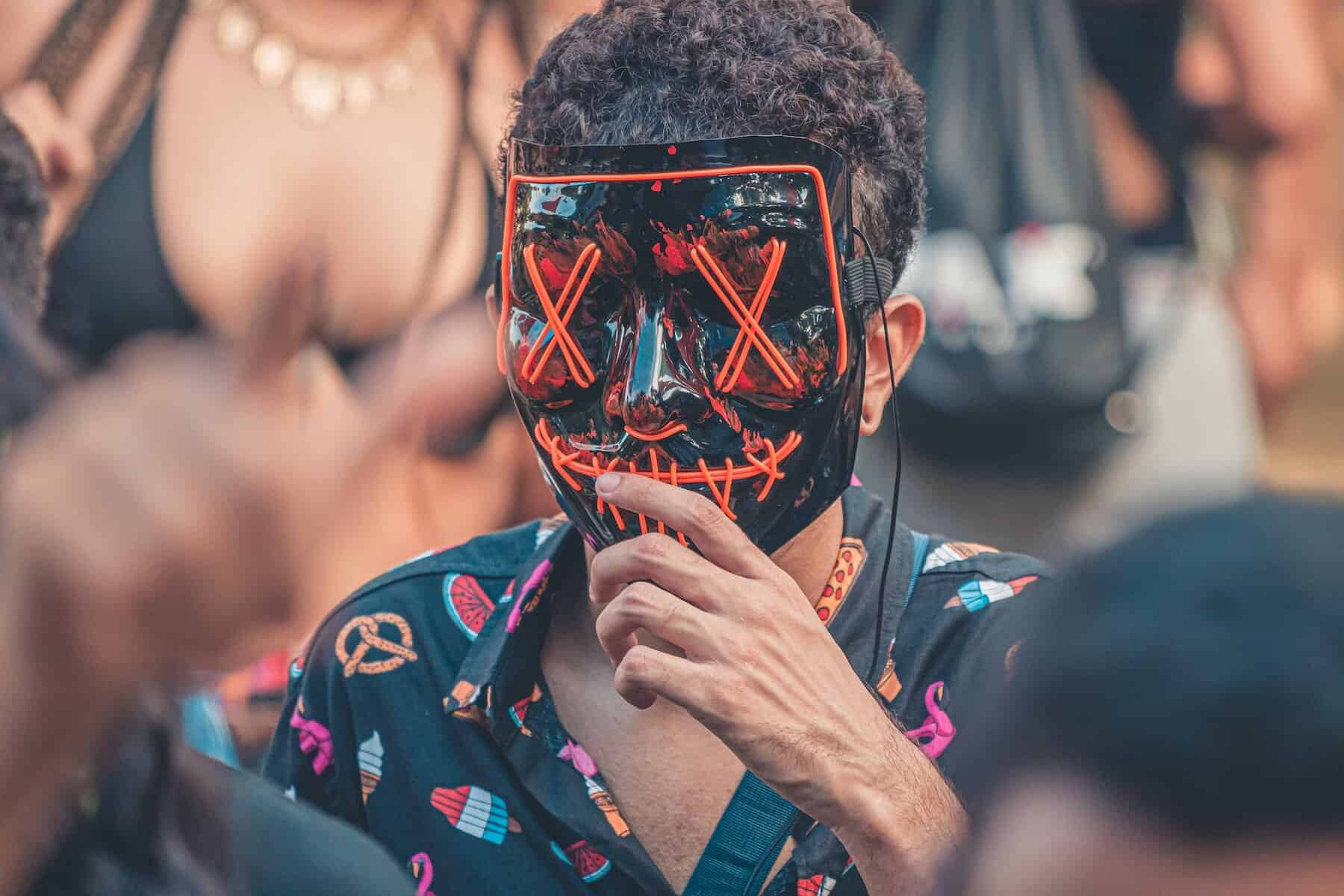 man in black and red purge mask