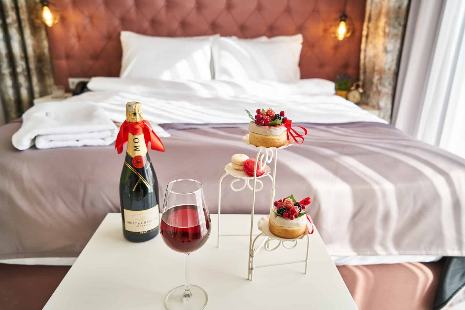 1. Sovrum med säng och champagne, romantisk inredning och lyxig atmosfär.
