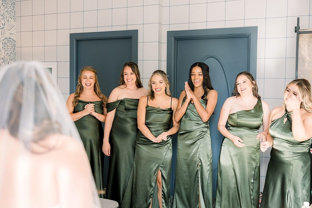 Bridesmaids seeing the bride in her dress for the first time