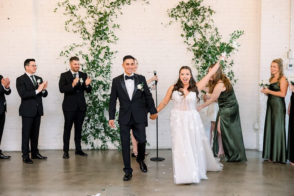 Bride and groom cheering after being announced as married
