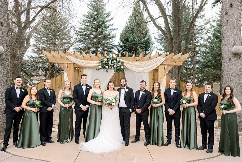 Bridal party in front of ceremony site at the Tapestry House