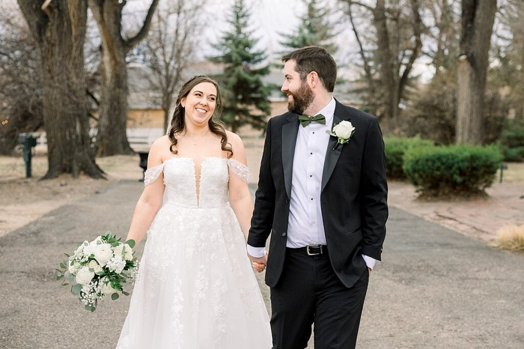 Bride and Groom walking down driveway of the tapestry house