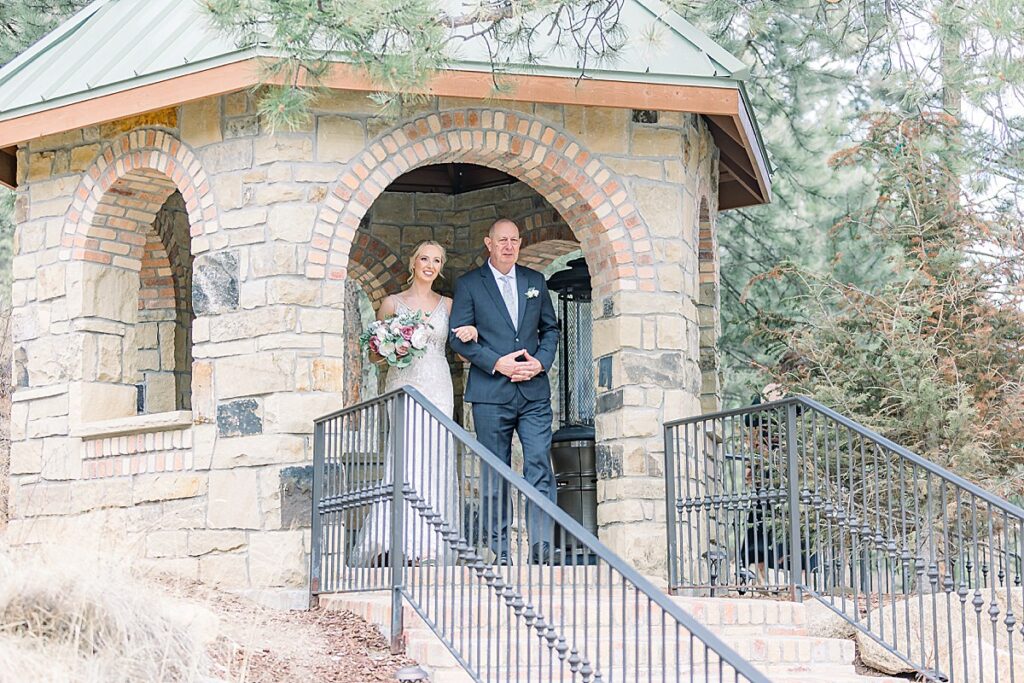 Bride and her father standing in gazebo before walking down isle