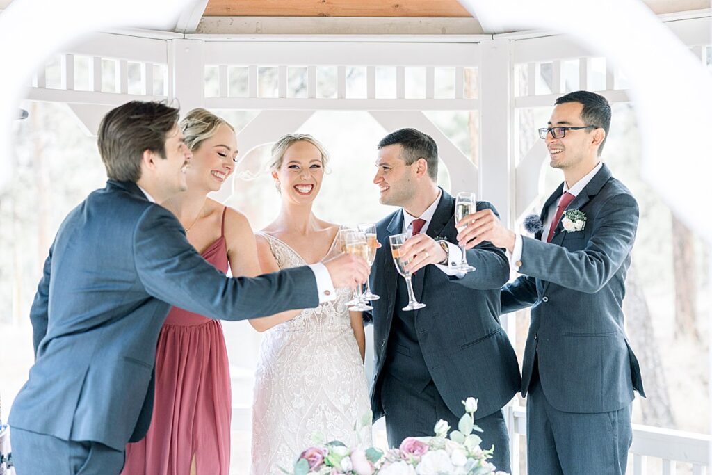 Bride and Groom toasting with best man and maid of honor after signing marriage license