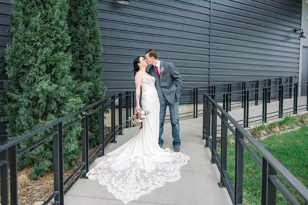 Bride and Groom sharing a kiss outside of the Mill