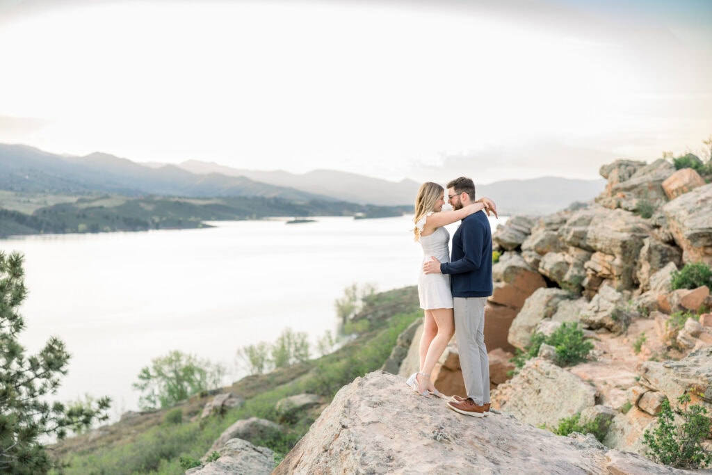 Couple facing each other with beautiful lake in the background