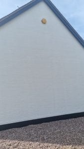 White exterior wall painted by professional decorators specialising in house painting services.