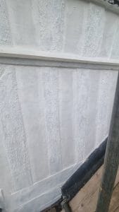 Uneven white wall plastering work at a construction site, showing textured surface finish.