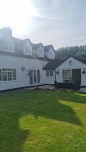 Bright white exterior house painting by S Bond Decorating showcasing professional residential decorating services.