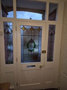 Stained glass door installation by S Bond Decorating in a UK home.