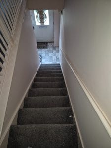 Bright white staircase walls painted by S Bond Decorating for a clean, modern look.