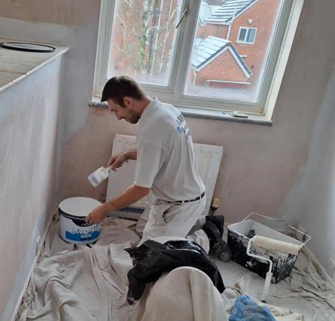 Smooth white interior wall painting by professional decorator in a residential room.