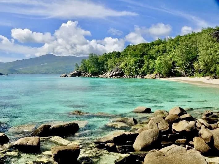 Anse Soleil Beach on Mahé, Seychelles, with tropical vegetation and turquoise water