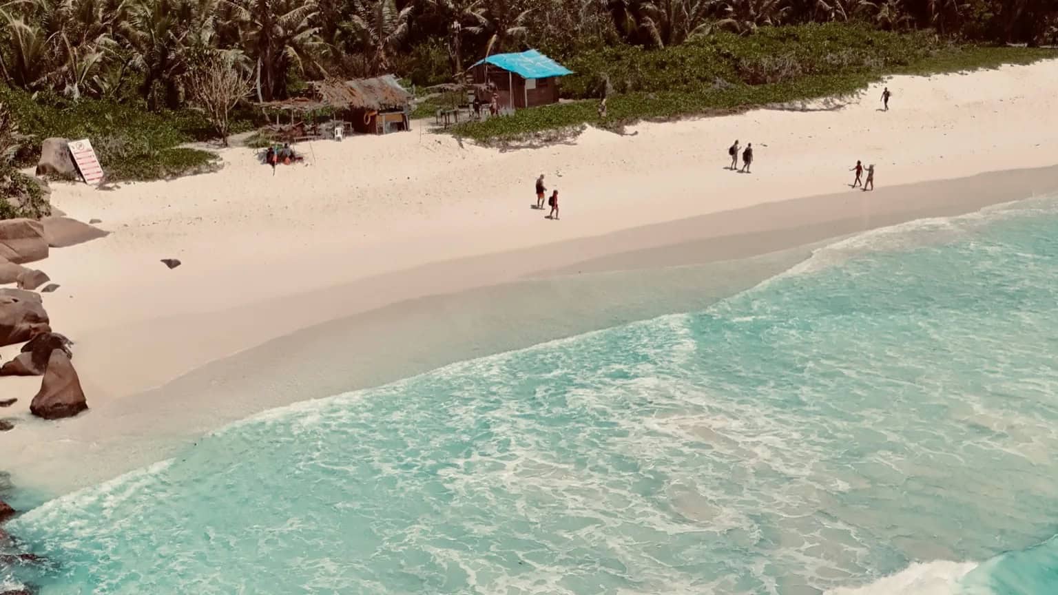 EN: Grande Anse, La Digue — vast wild bay with powerful waves and bright white sand | FR: Grande Anse, La Digue — grande baie sauvage aux vagues puissantes et sable blanc éclatant