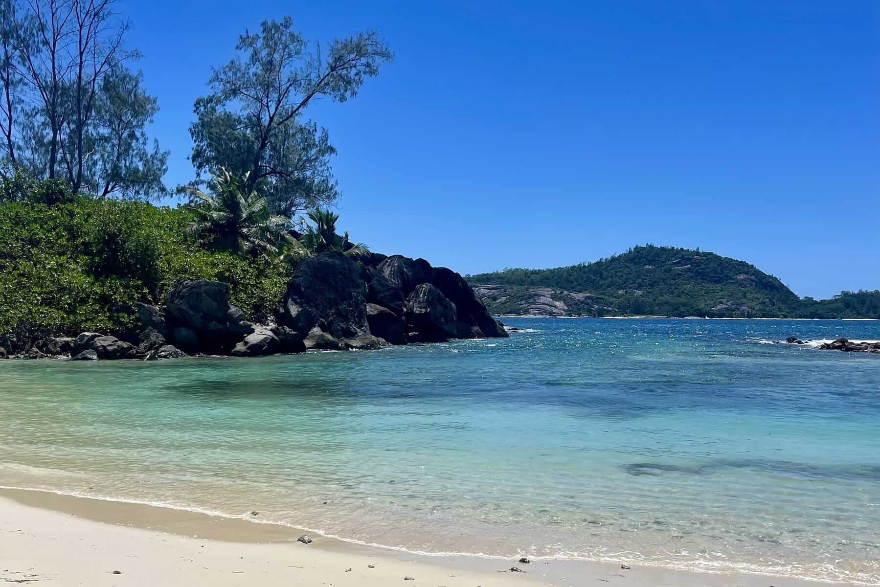 Port Glaud Beach Mahé Seychelles with tropical coastline and shallow turquoise water