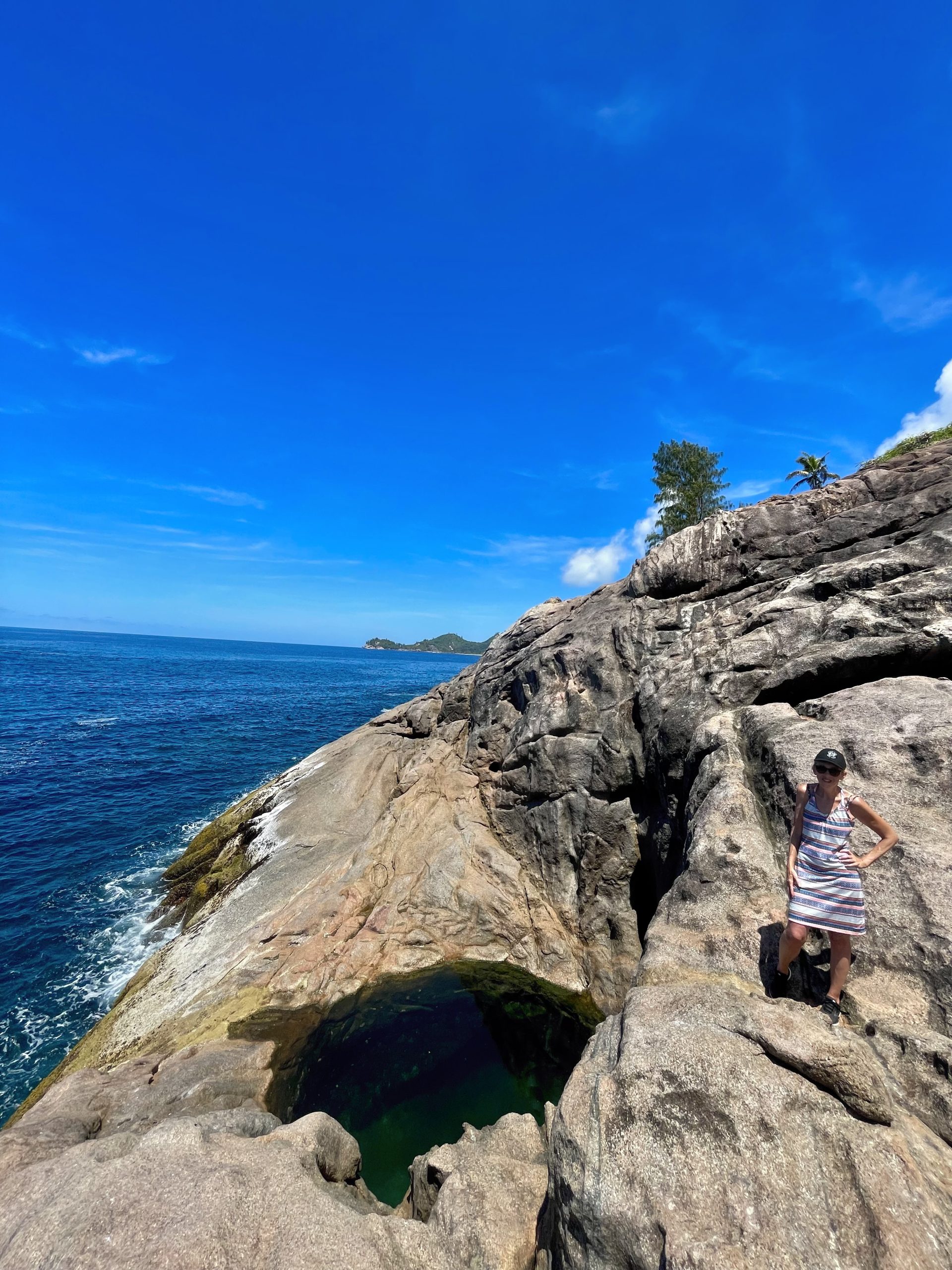 Ros Sodyer Mahé 2 Vertical view of Ros Sodyer rock pool and granite coastline with a visitor standing back from the water