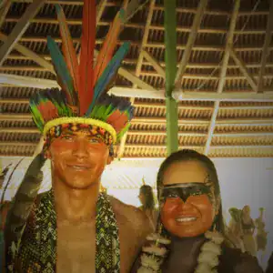 Healer in traditional indigenous costume with feather headdress and face paint, offering spiritual or cultural ceremonies, emphasizing connection to native traditions and shamanic practices.