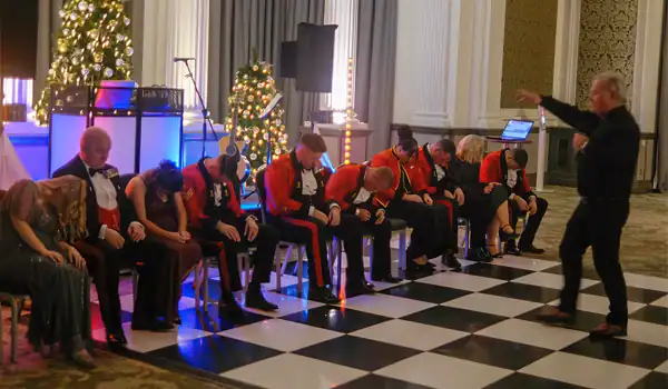 Hypnotist performs for an audience asleep on chairs.