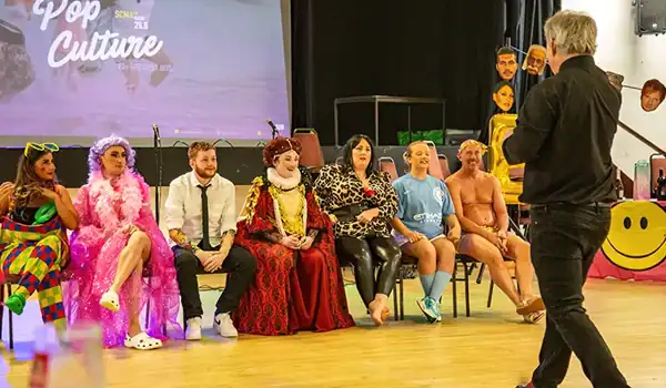 People in costumes at a pop culture event.
