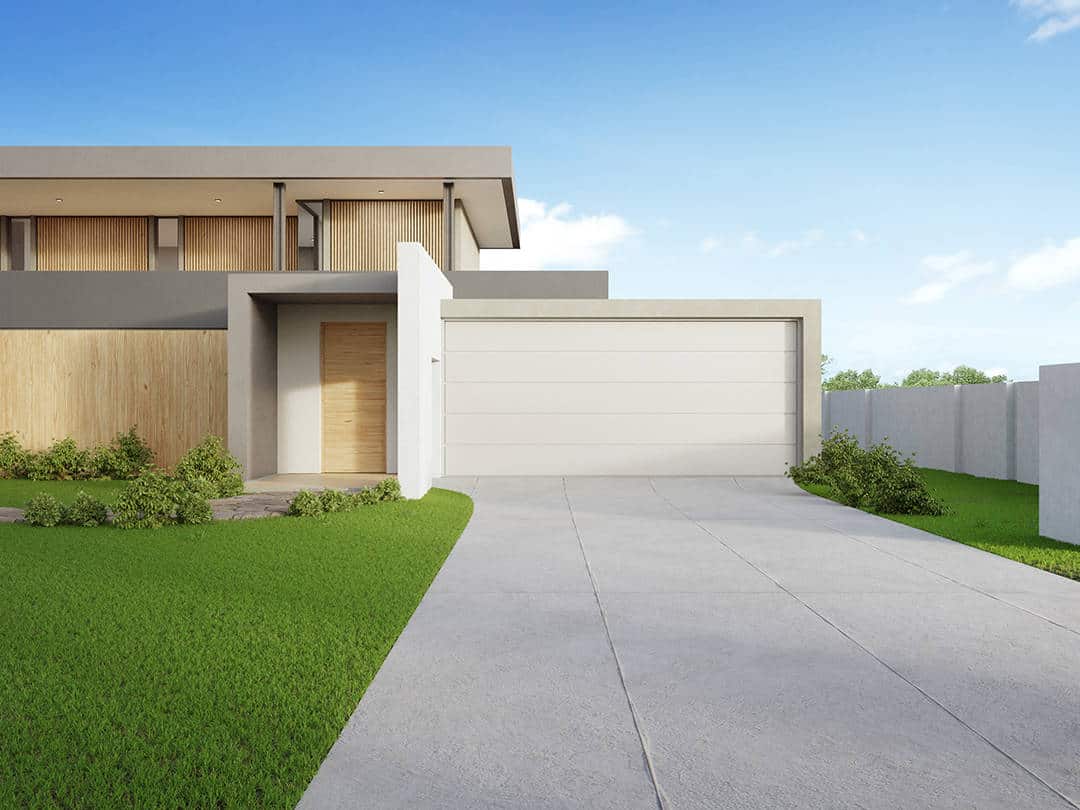 A garage door on a modern house with a paved driveway