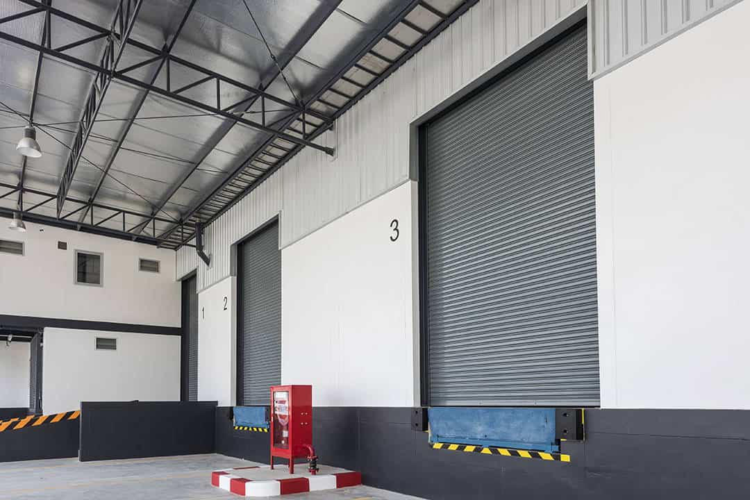 A closed industrial roller shutter door at a loading bay