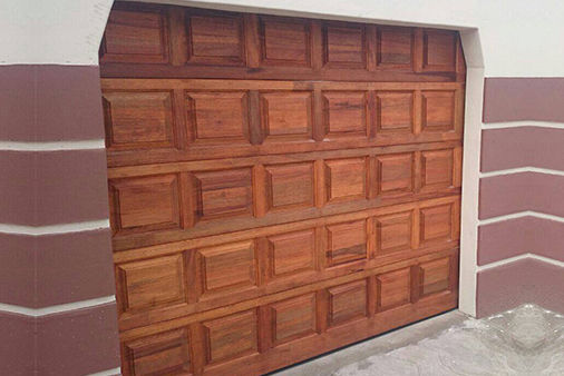 A timber raised-panel garage door