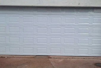 A steel garage door on a modern house
