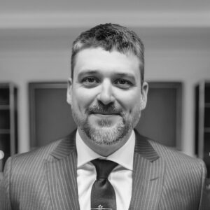 Professional portrait of a man in a suit at Skyler Construction.