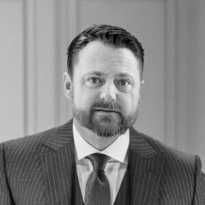 Professional portrait of a man in a suit, representing Skyler Construction services.