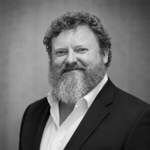 Professional portrait of a man with a beard in a suit for Skyler Construction.