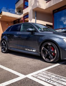 Audi door decals applied to black car side skirt