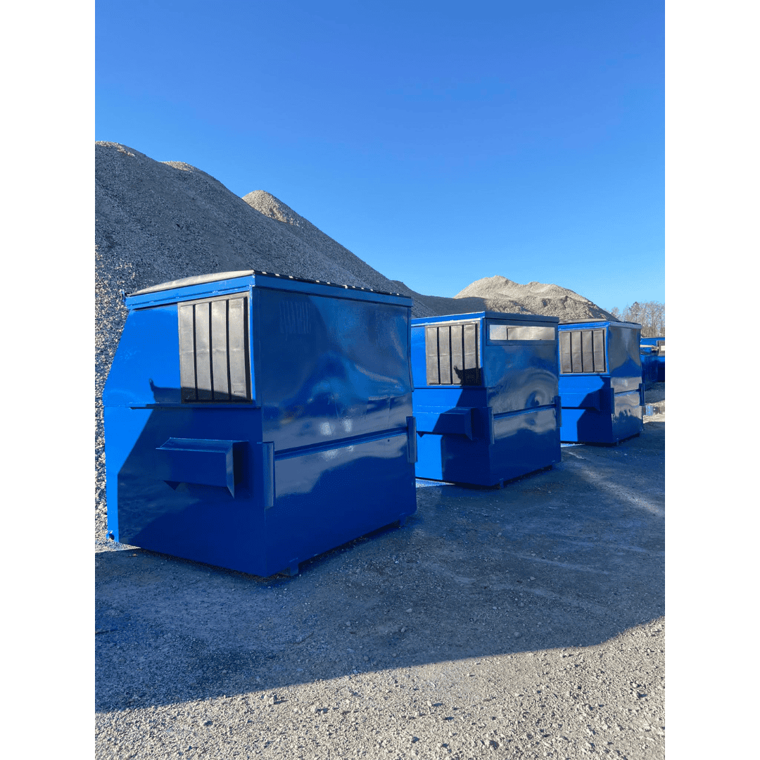 Blue container storage units on gravel with mountain backdrop, ideal for construction and industrial.