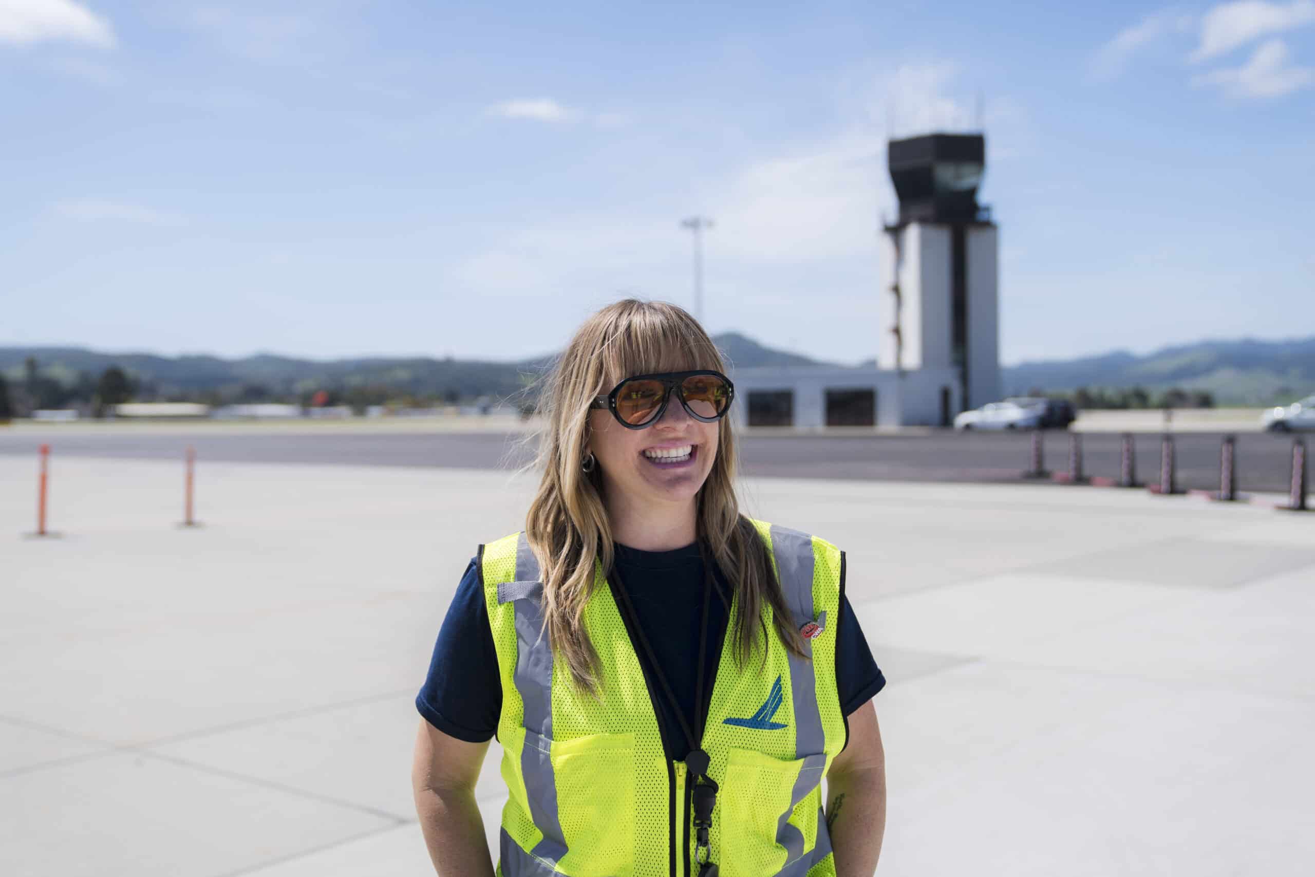 Woman SLO airport worker in safety vest