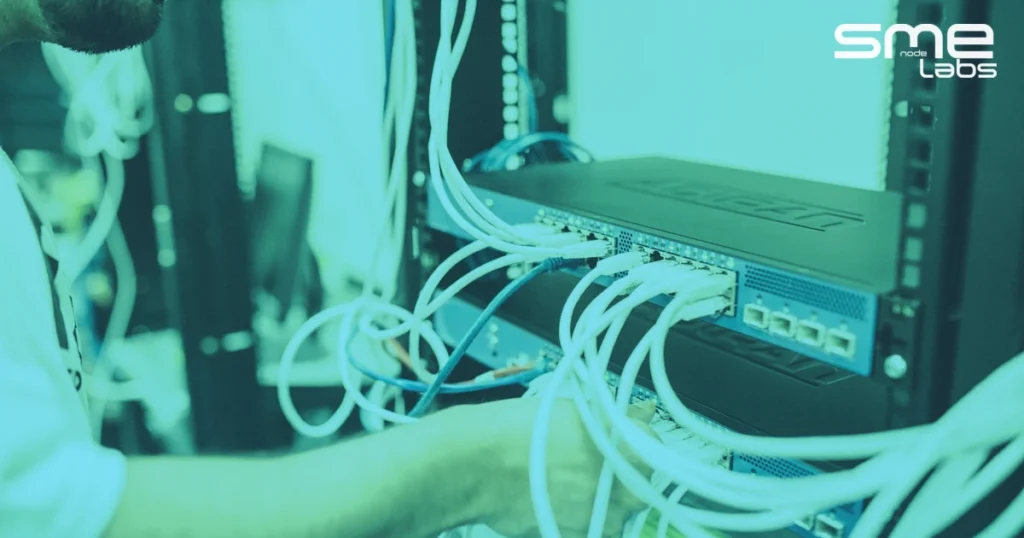 GNS3 vs EVE-NG, IT engineer connecting Ethernet cables in a server rack