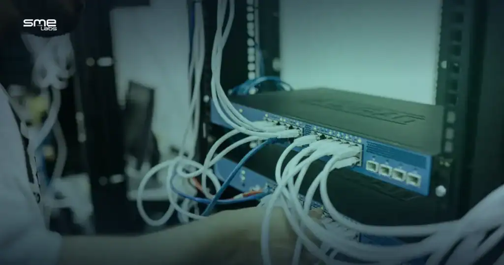 Network switch with multiple Ethernet cables connected in a server room.