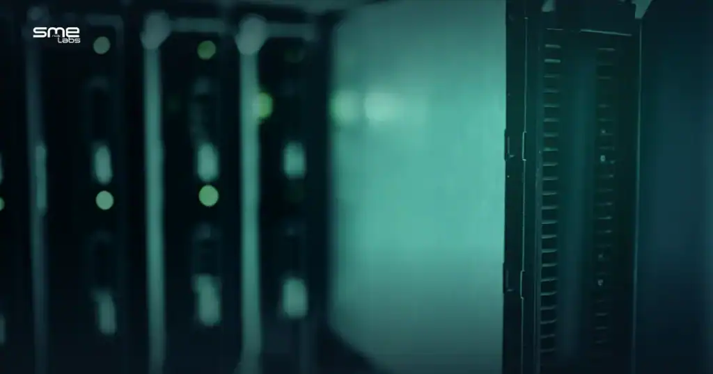 Close-up of a server drive sliding into a rack, lit in teal-blue tones