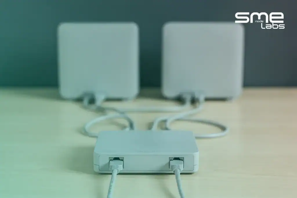 A router connected by two Ethernet cables to two separate modems, representing MikroTik failover between two ISPs