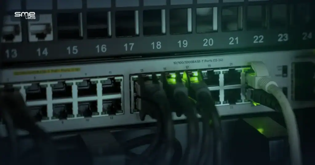 Close-up of a network switch with patch cables plugged into labelled ports