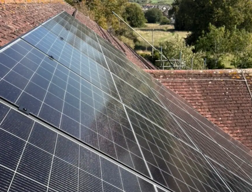 High-efficiency solar panels installed on a sloped roof for sustainable energy solutions. Perfect for reducing energy bills and promoting eco-friendly living.