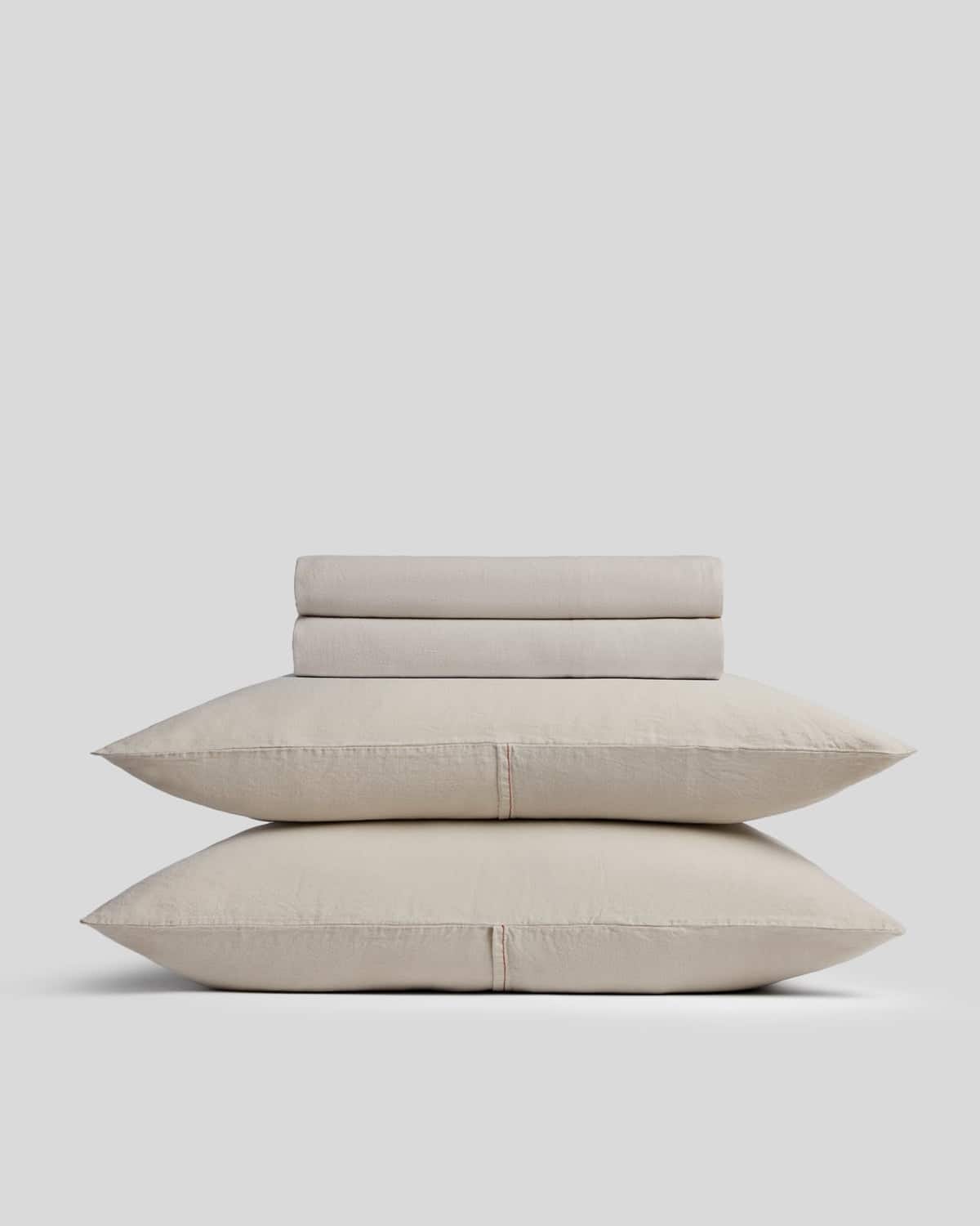 Neutral linen and Tencel sheets on a made bed