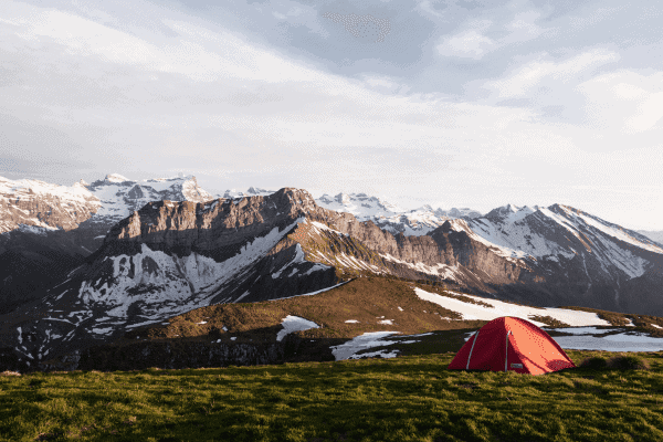 Tent Re Waterproofing: The Ultimate Guide to Reviving Your Shelter 2 Tent pitched in front of a mountain backdrop.