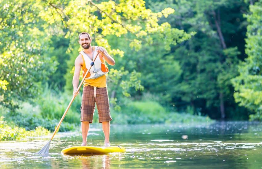 11 Best Life Jackets for Paddle Boarding (SUP) in 2025 16 Man on SUP