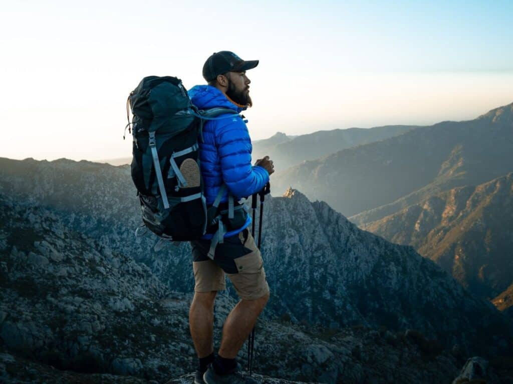 UK Camping Guide: Wild Camping, Gear & Safety Tips (2025) 18 Man wear his backpack whilst hiking