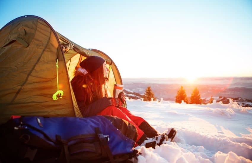 15 Easy Tips on How to Insulate a Tent for Winter Camping 2 Girl in her tent surrounded by snow