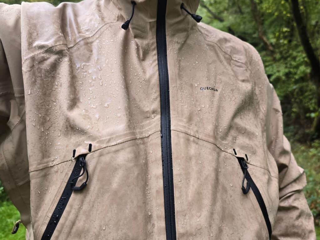 Quechua MH500 Waterproof Jacket Review (2026) 5 Quechua MH500 Waterproof Jacket in heavy rain with water beading on the surface of the jacket